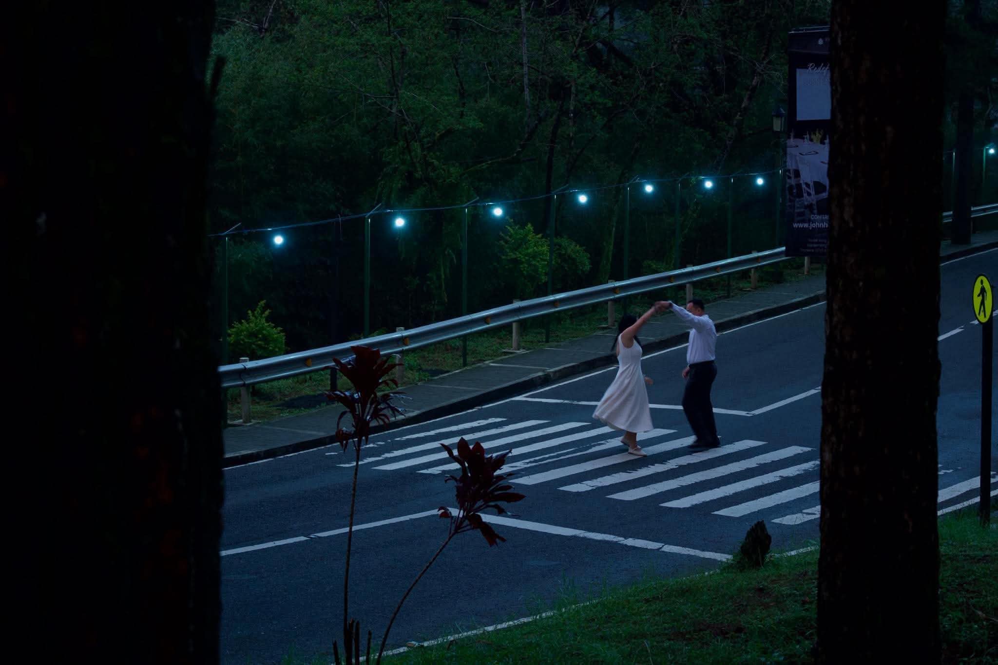 Syd and Franz dancing on a pedestrian crossing in Baguio at dusk
